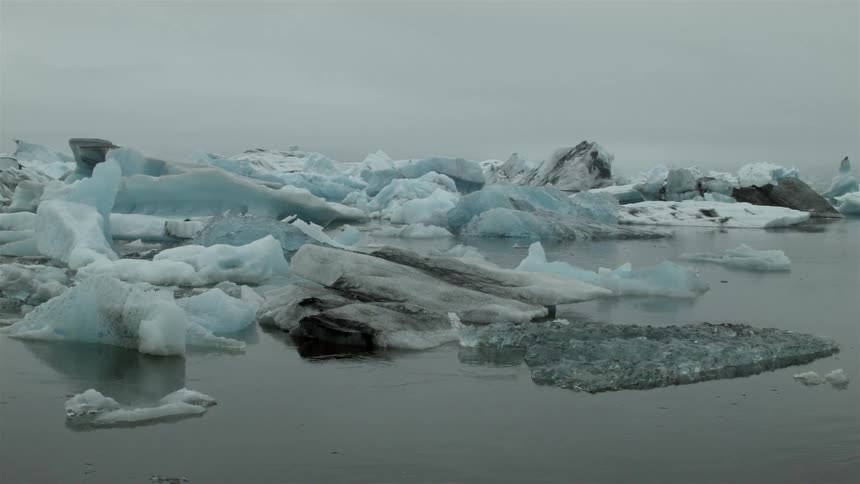 Ice formations sticking out of cold waters