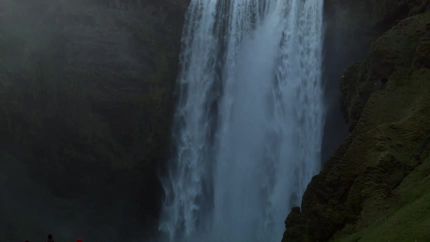 A waterfall is pouring down below