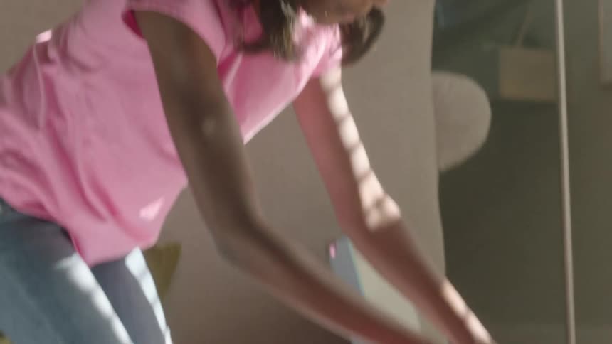 A girl opening a pencil case on the floor