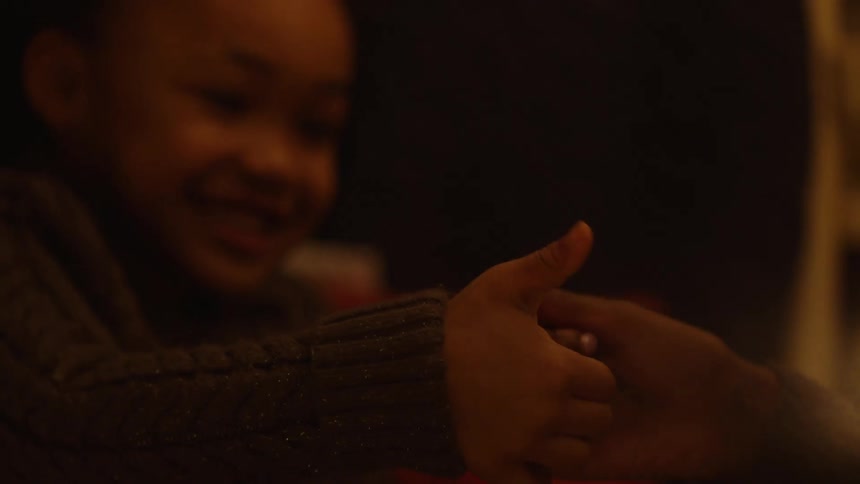 Mother and daughter playing hand games in the bedroom