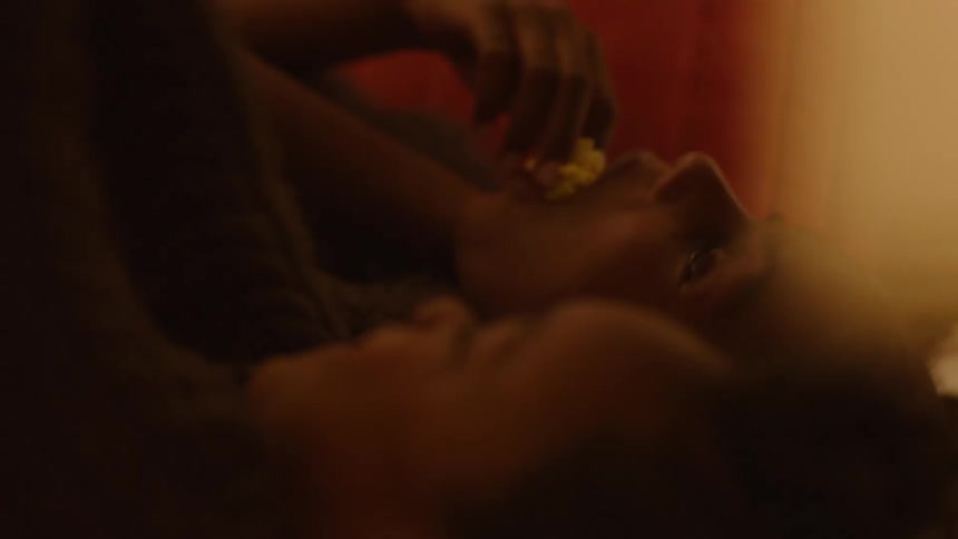 Sisters lying in bed pointing at the ceiling