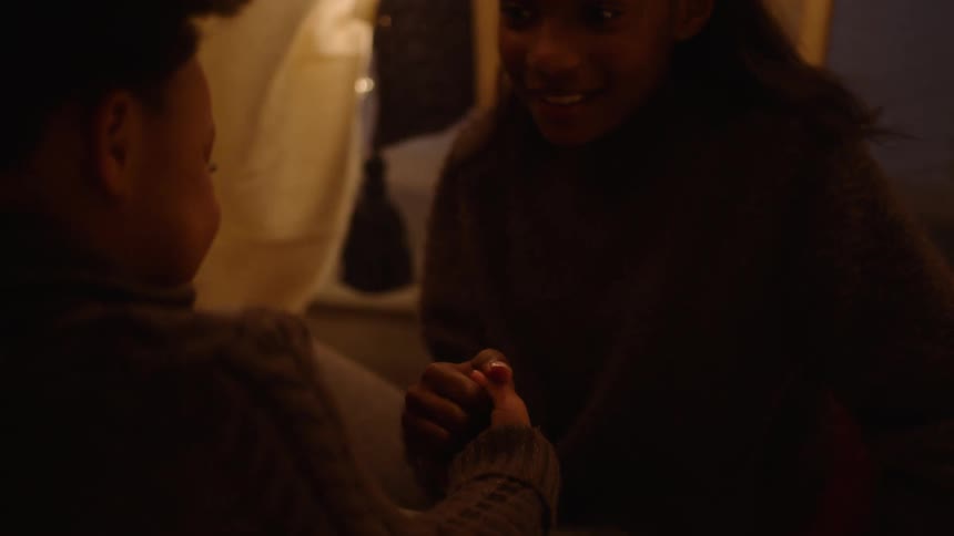 Portrait of two friends playing with their hands