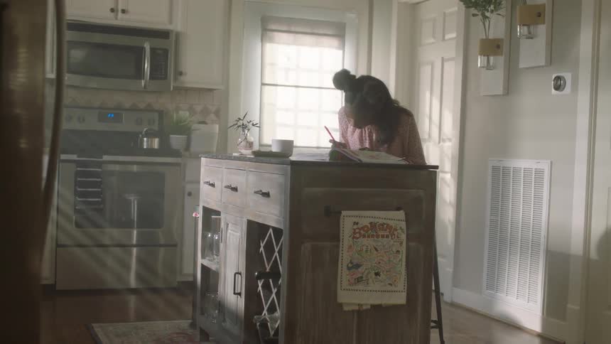 Girl doing homework in the kitchen