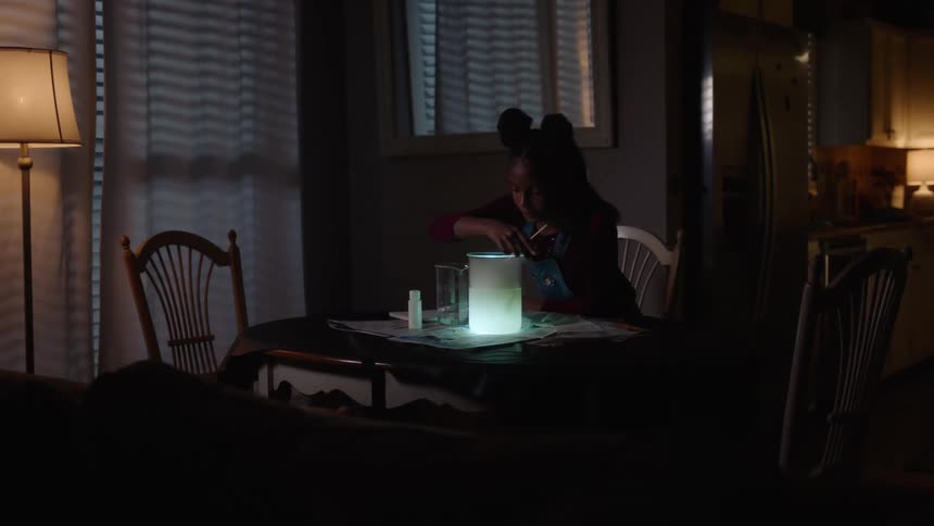 Girl plays with an experiment for homework
