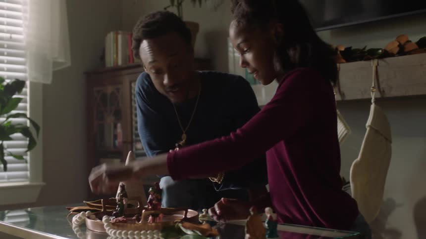 Father and daughter sticking figurines on a wooden boat