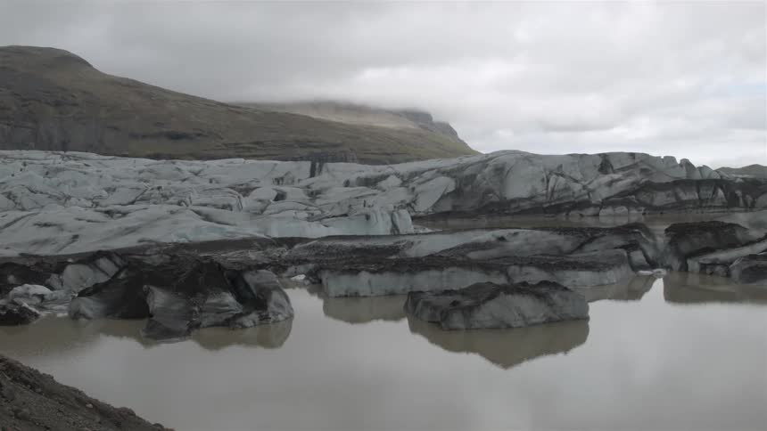 Gray rocks next to calm waters