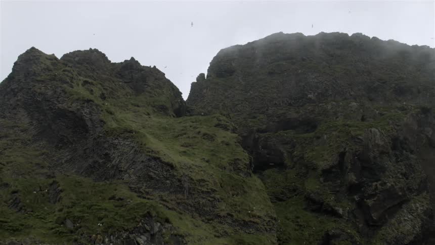 Birds fly around this mountain