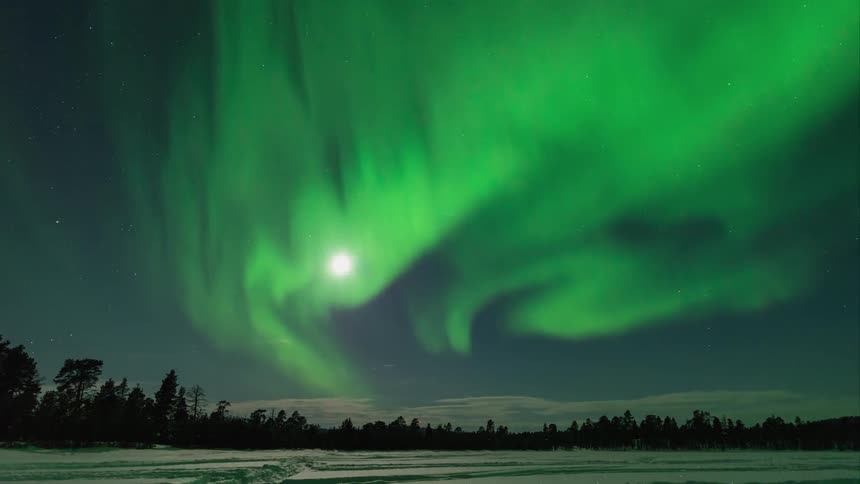 The moonlit skyline has green aurora flares swirling around