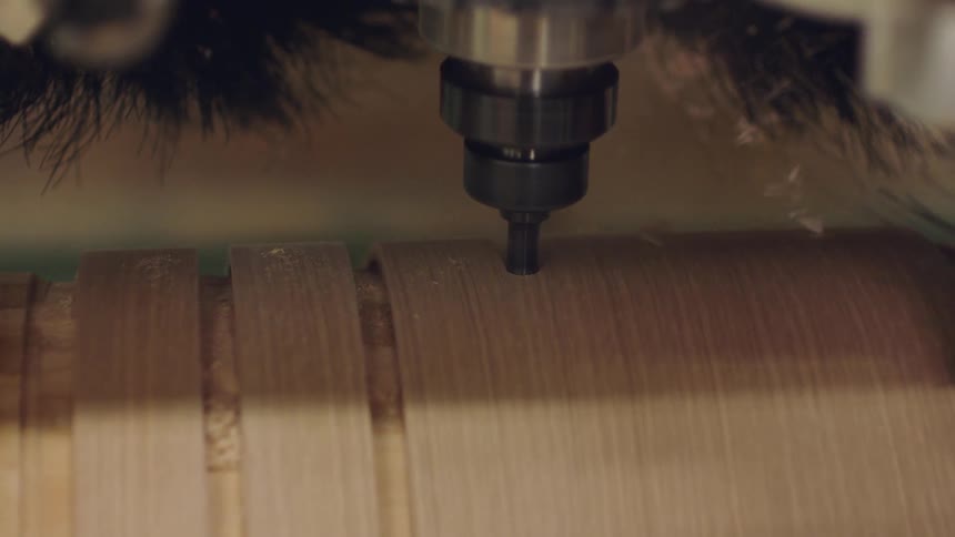 Machine carves channel in curved wooden surface
