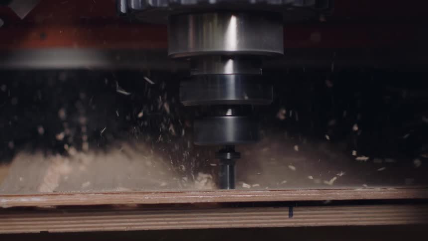 Machine making cuts on a wooden board