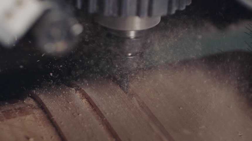 Machinery making cuts on a wooden board