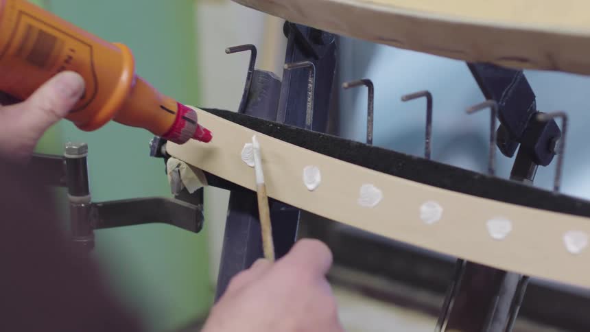 A person is applying paste on the device