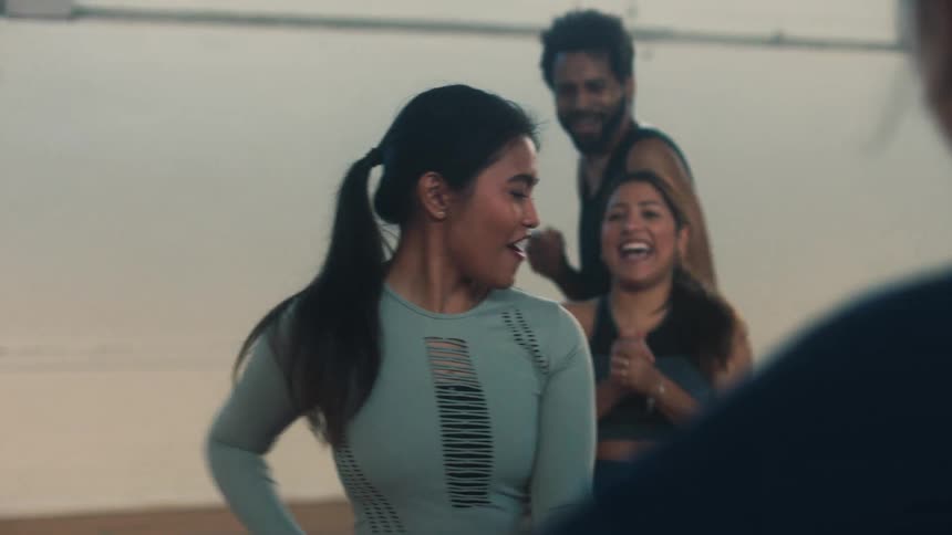 Woman dancing in a circle of happy friends