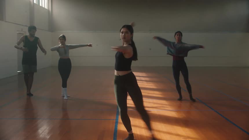 Ballet teacher instructing students on a dance studio
