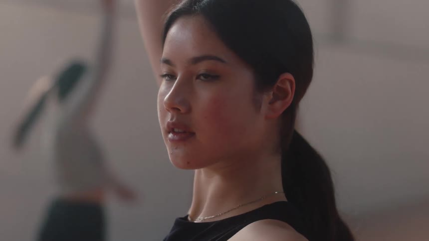 Portrait of a young woman twirling her body and arms in a ballet dance
