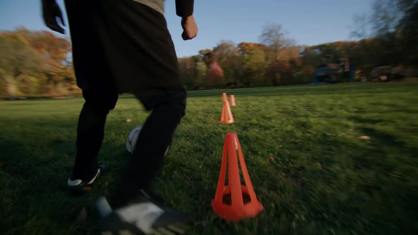 A child is kicking the soccer ball