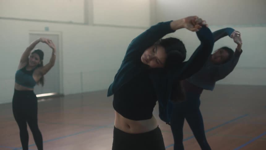 Dance students stretch in the studio