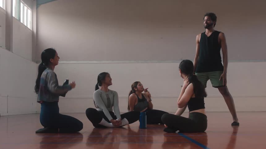 A group of dancers chatting as they warm up