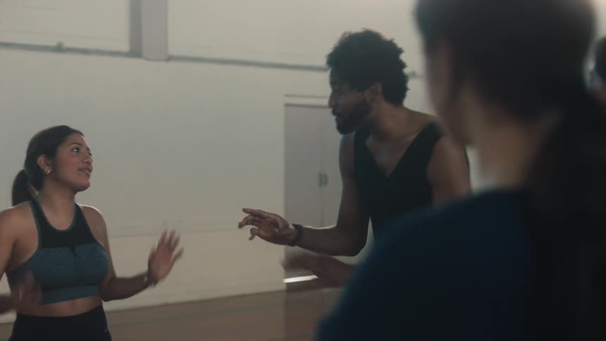 A dance teacher teaching dance steps to students