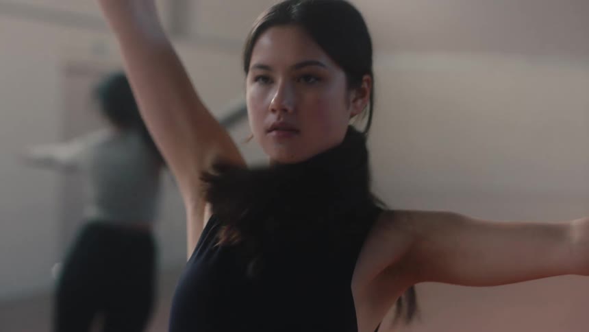 A young girl doing dance moves