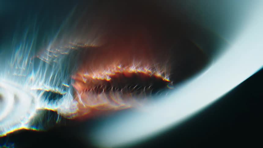 Some flashes of orange and blue light reveals the inside of an electric motor