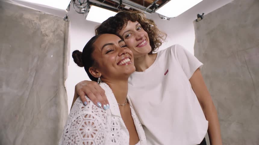 Three women modeling in a studio