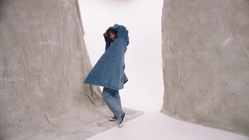 A model is dancing around in clothing
