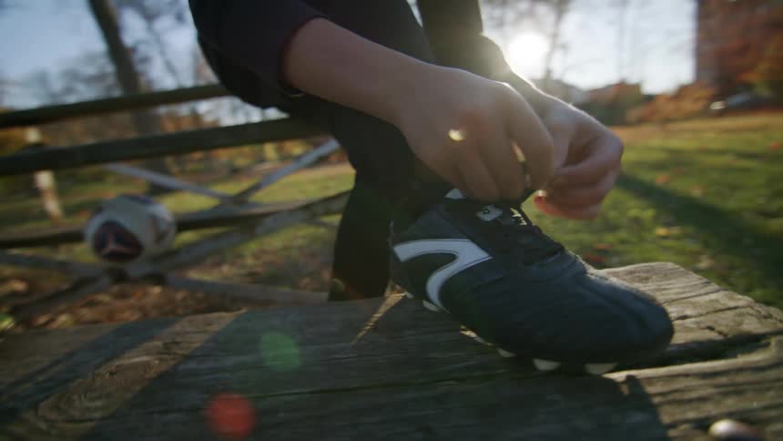 A child tying his boot laces