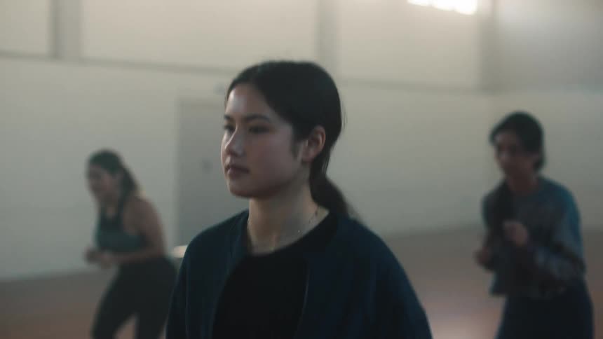 A young girl doing warmup exercises