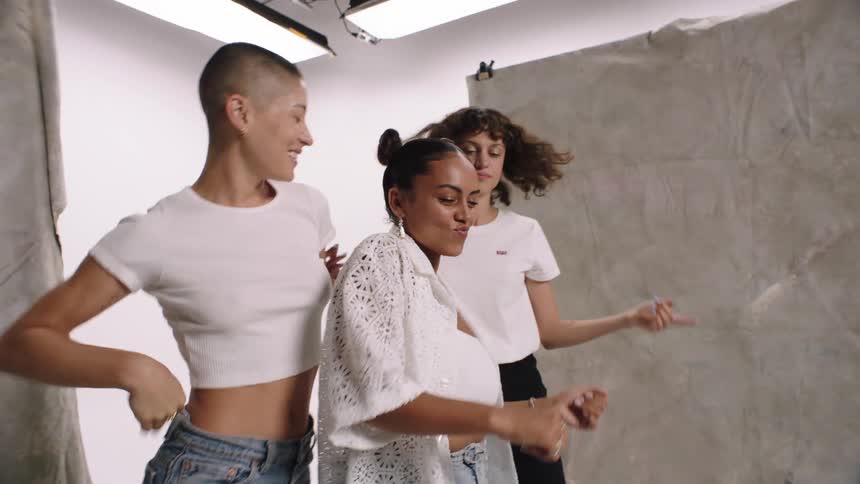 Three women smiling while posing indoor