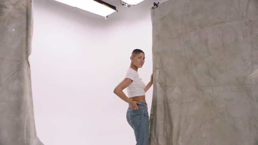 Young happy woman with a buzz cut dancing
