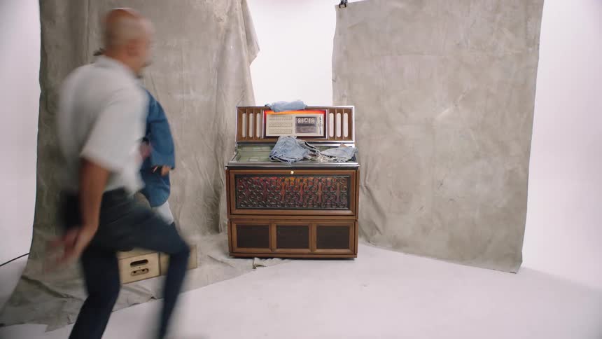 Models in a studio picking up shorts and jeans in a presentation dancing quirky friends photograhy white cyc