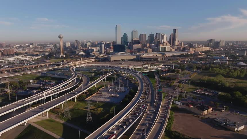 Multiple highway leading in and out of the city as cars go by