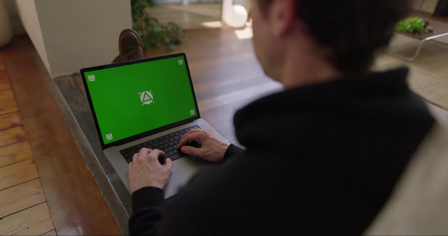 Man typing on a laptop with a replaceable screen