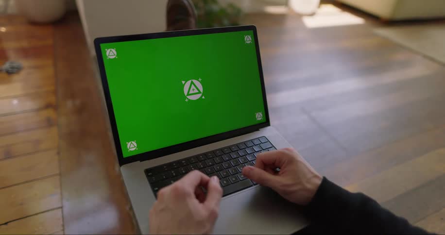 Hands of a man on a laptop indoor during the day