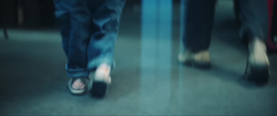 Closeup of a child walking inside a workshop and falling on the floor