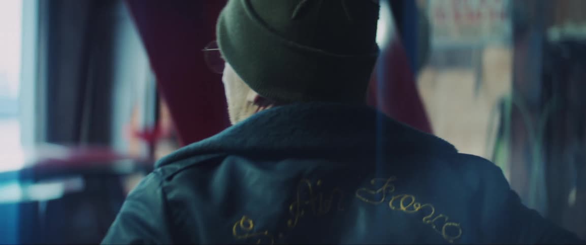 Man inside a workshop wearing a jacket