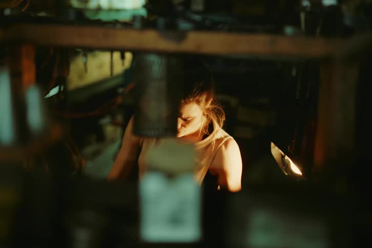 Woman sitting and working in a workshop