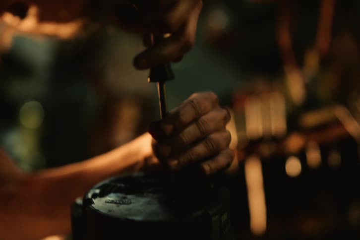 A person dismantling an engine part