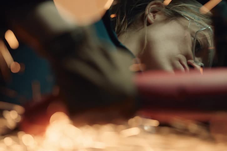 Portrait of a mechanical woman using a sparking tool