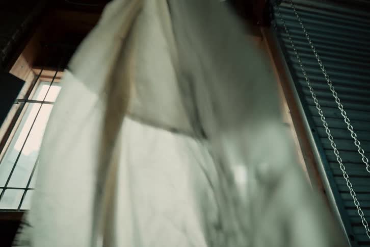 A white sheet hanging from a garage window