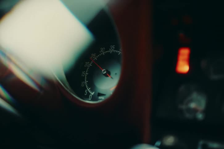 Keys hanging from an ignition are turned and the needle moves quickly around rmp gauge over halfway then falls back back down