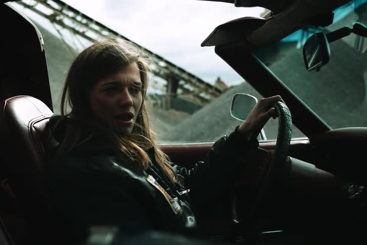 A sad woman driving a car while crying