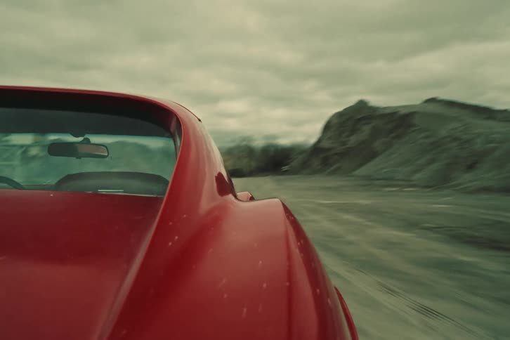 A car driving on a wide dirt road