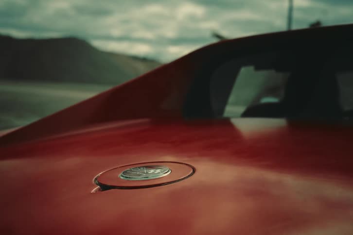 View from the rear of a classic red sports car in motion
