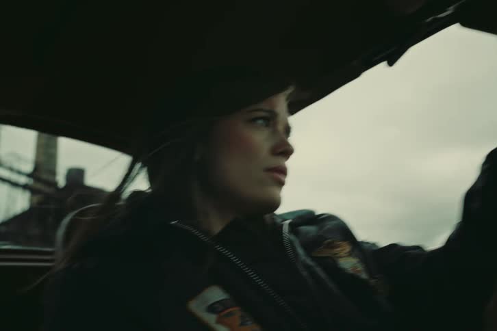 Portrait of a young woman driving a car
