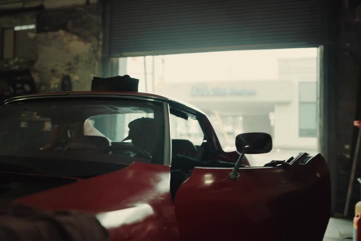Mechanic woman working on the vehicles engine and then sitting in the drivers seat