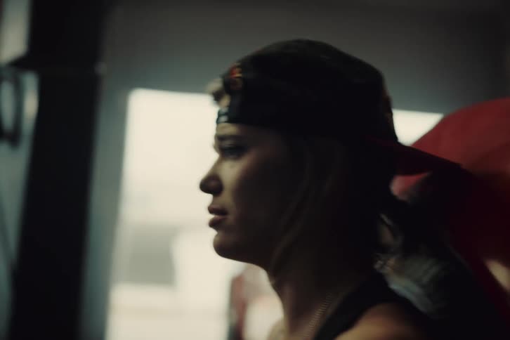 A sad woman looking at the car engine
