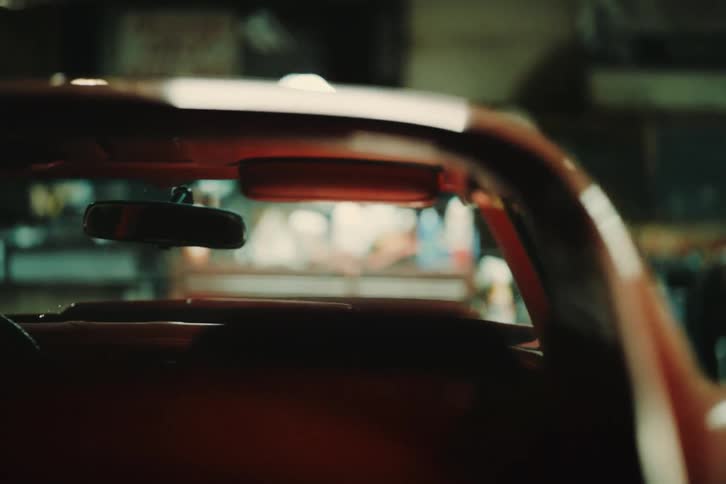 A small red car parked inside a garage