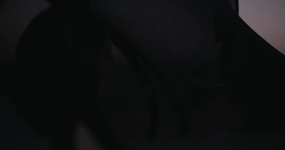 Woman inside a tent turning off a hanging light